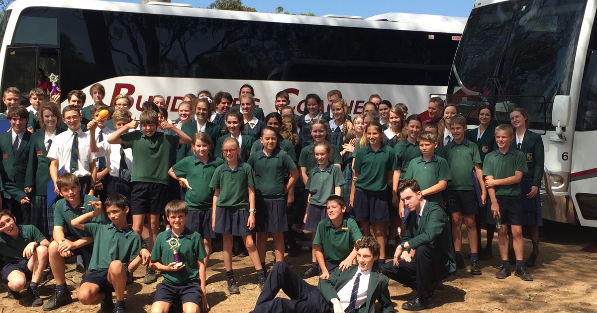 School children in front of hired bus